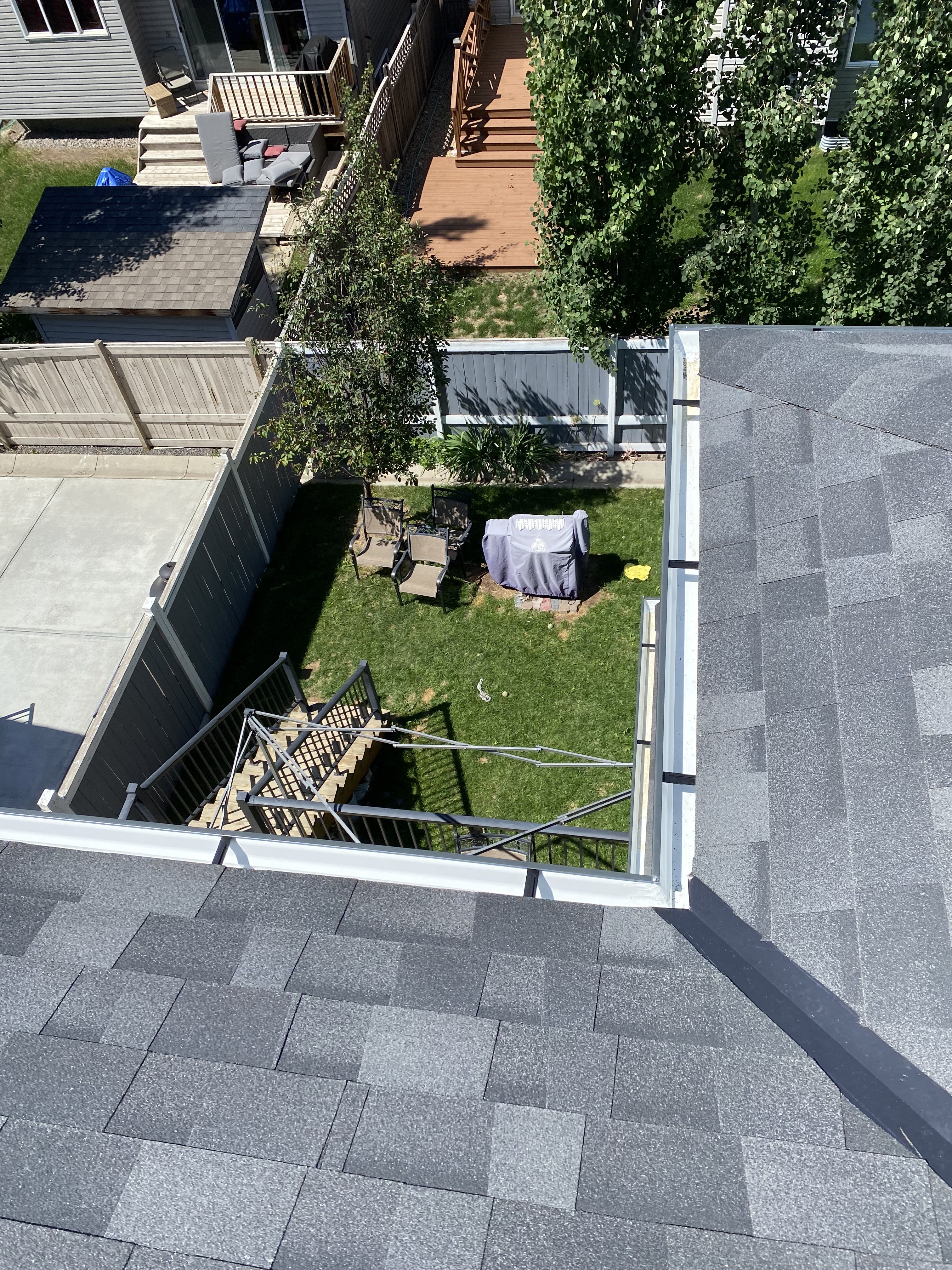 Aerial view of sealed eavestrough corners on a Calgary roofline