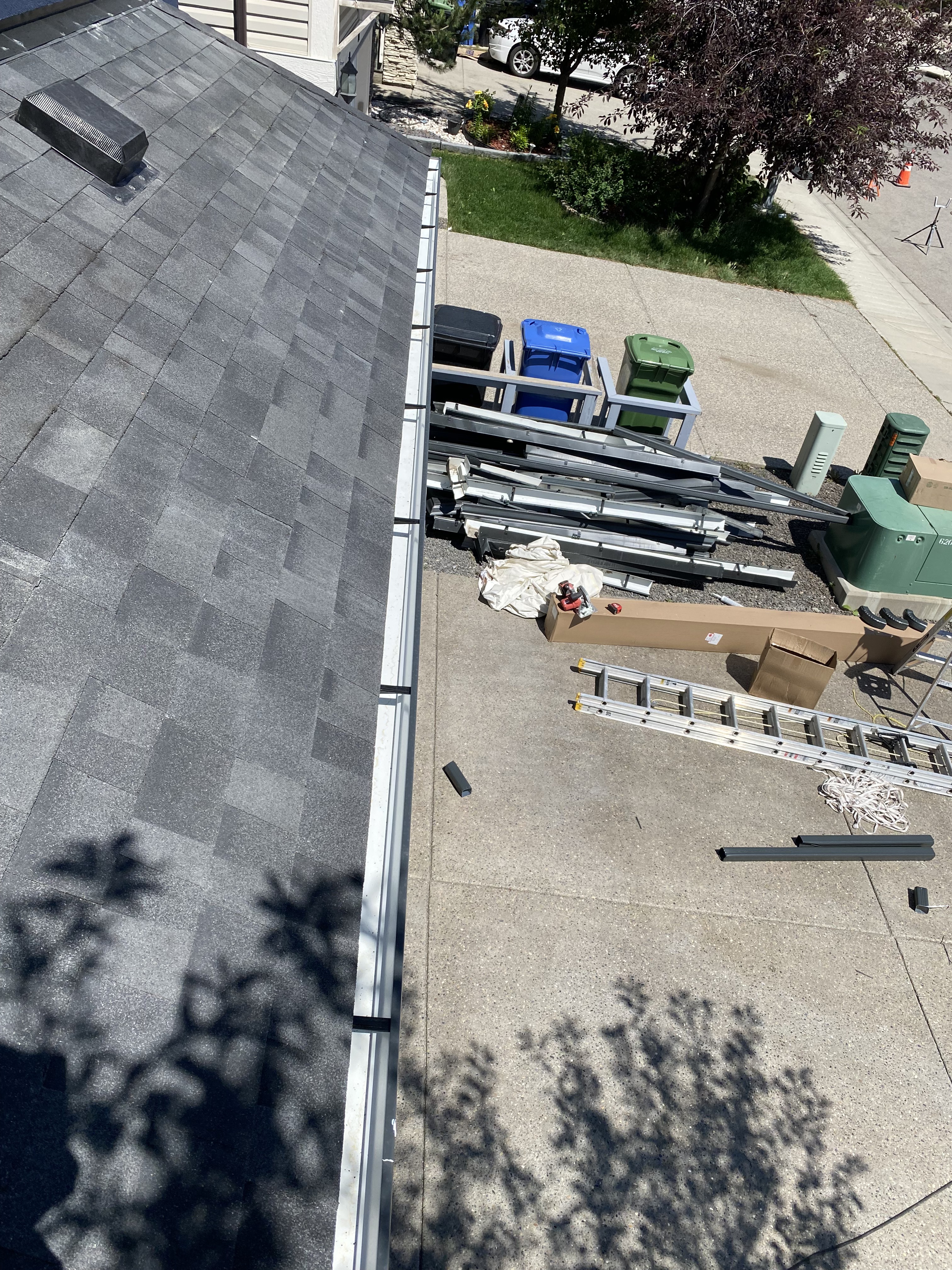 Eavestrough installation supplies staged on a Calgary rooftop