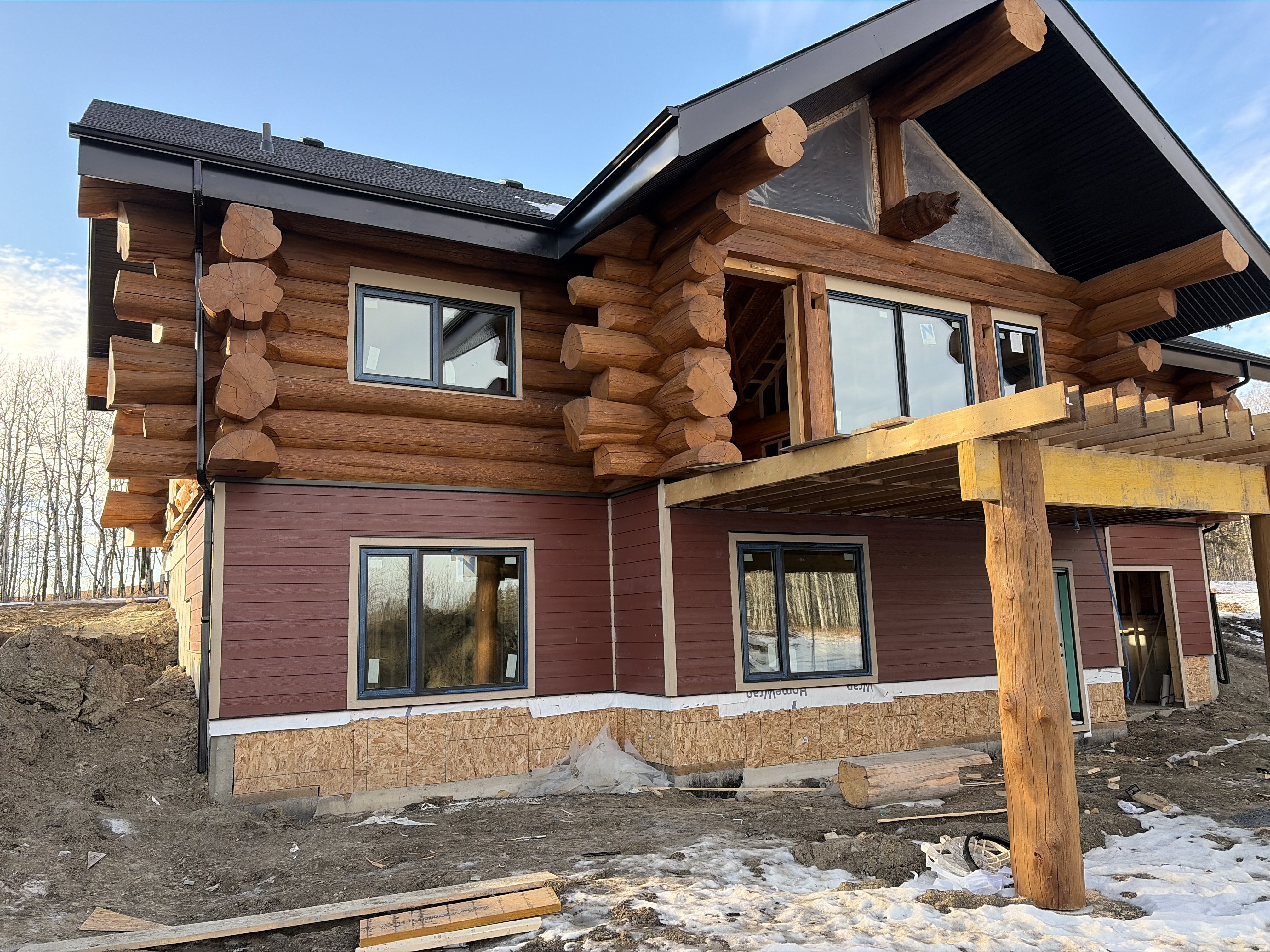 Log home with mixed siding cabin exterior