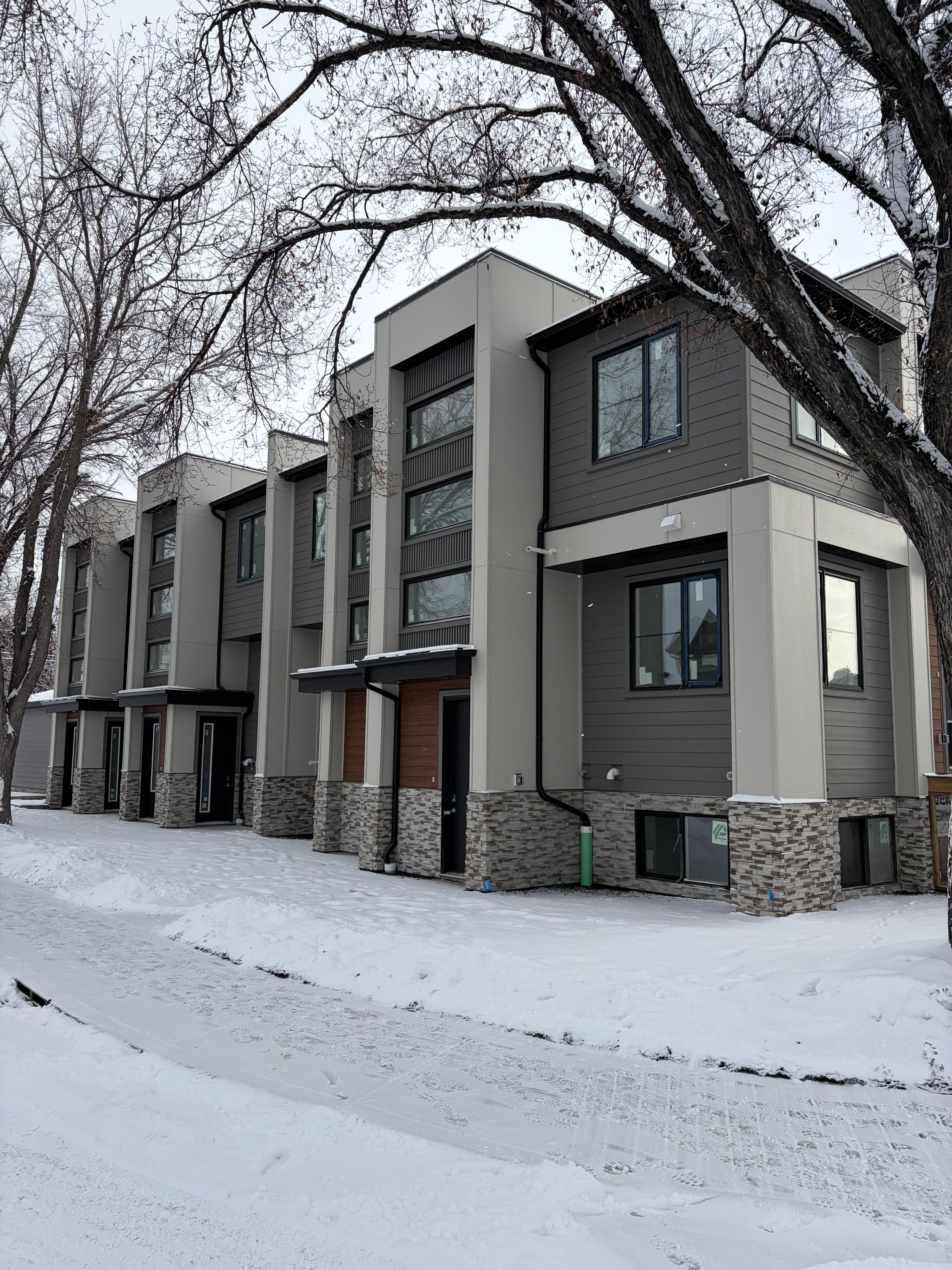 Modern grey Calgary townhome exterior in winter snow