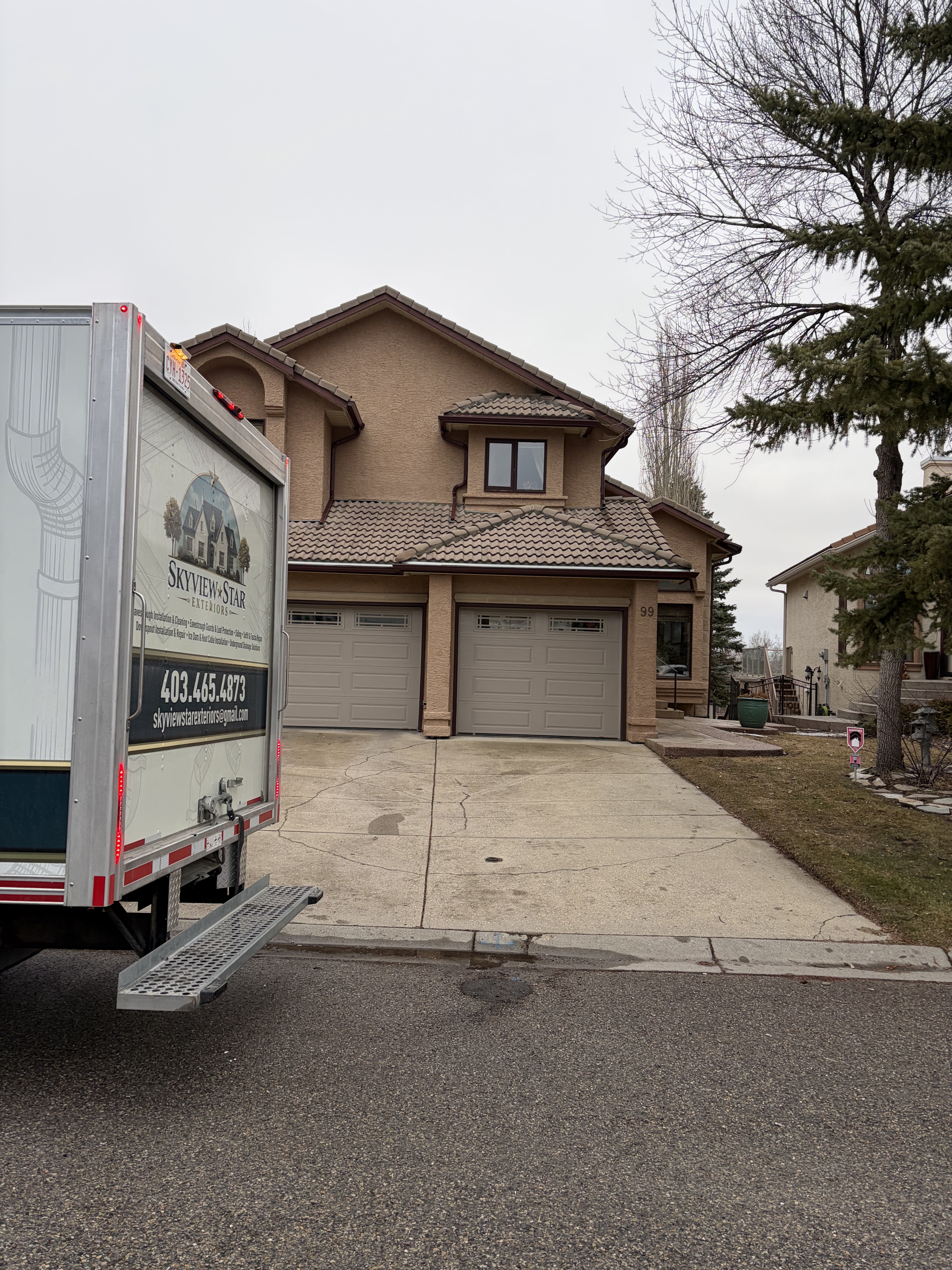 Skyview Star Exteriors truck on a Calgary stucco bungalow jobsite