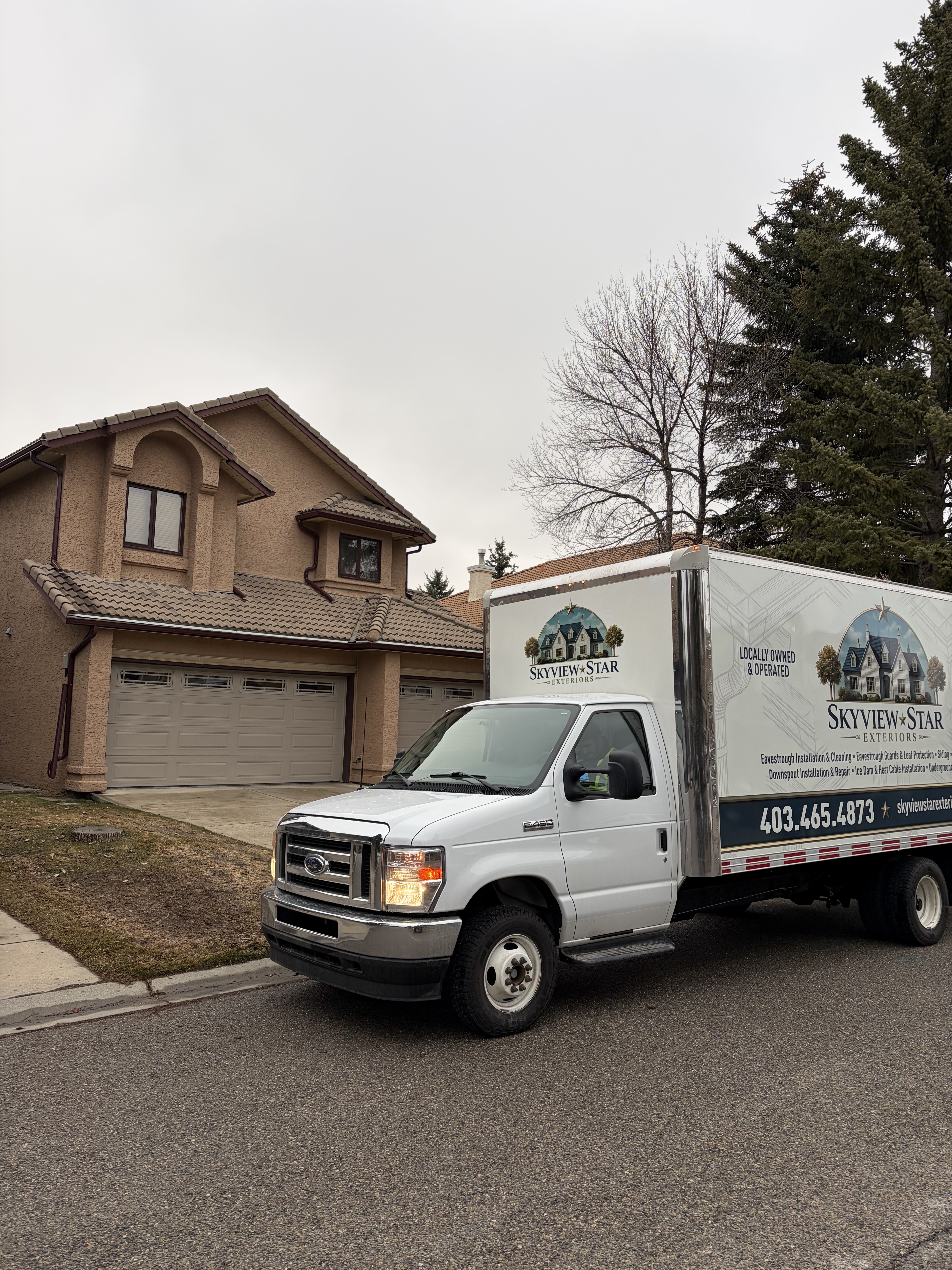 Skyview Star Exteriors truck parked in front of a Calgary stucco home