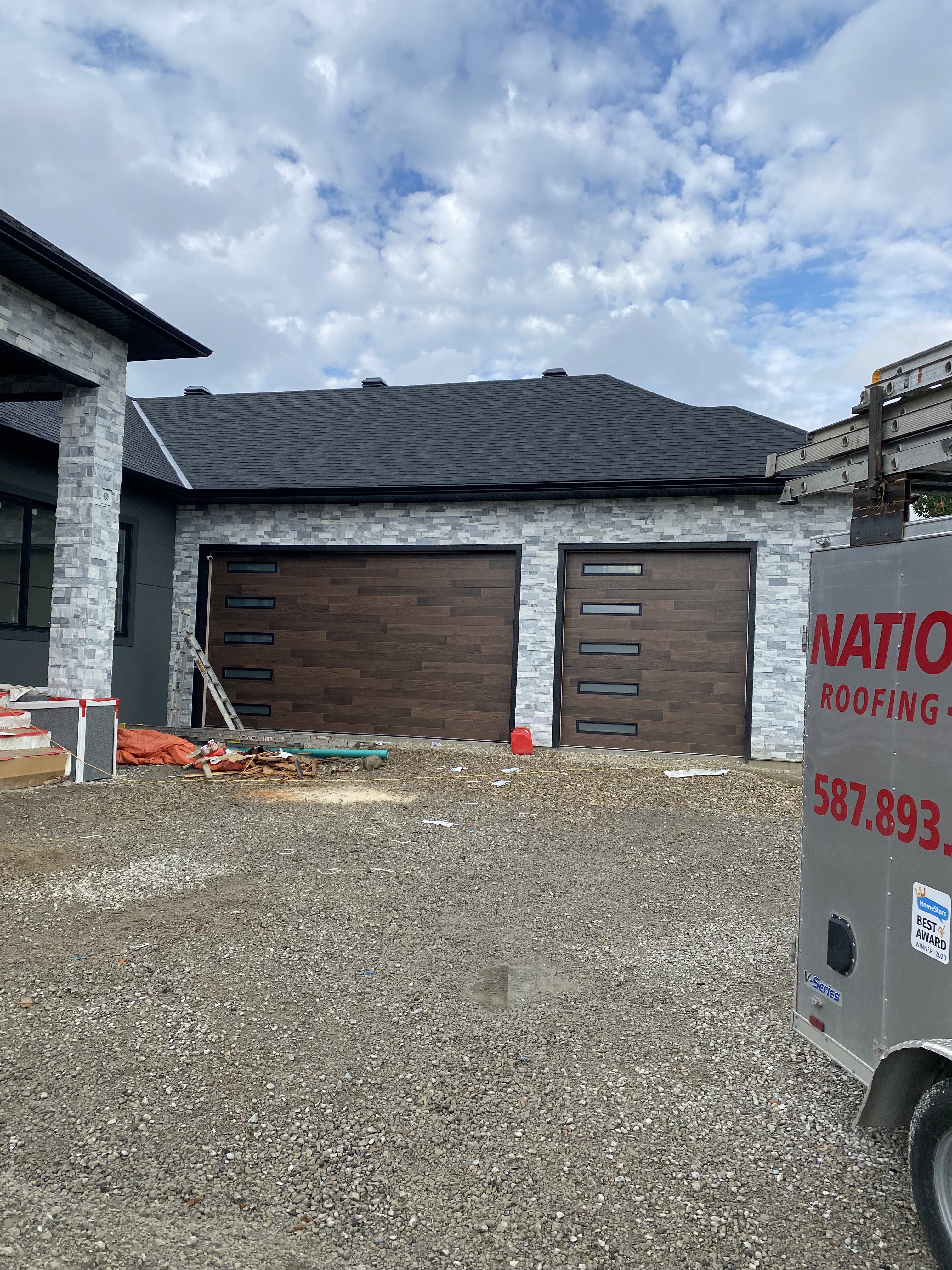 Wood-look garage doors on stone home