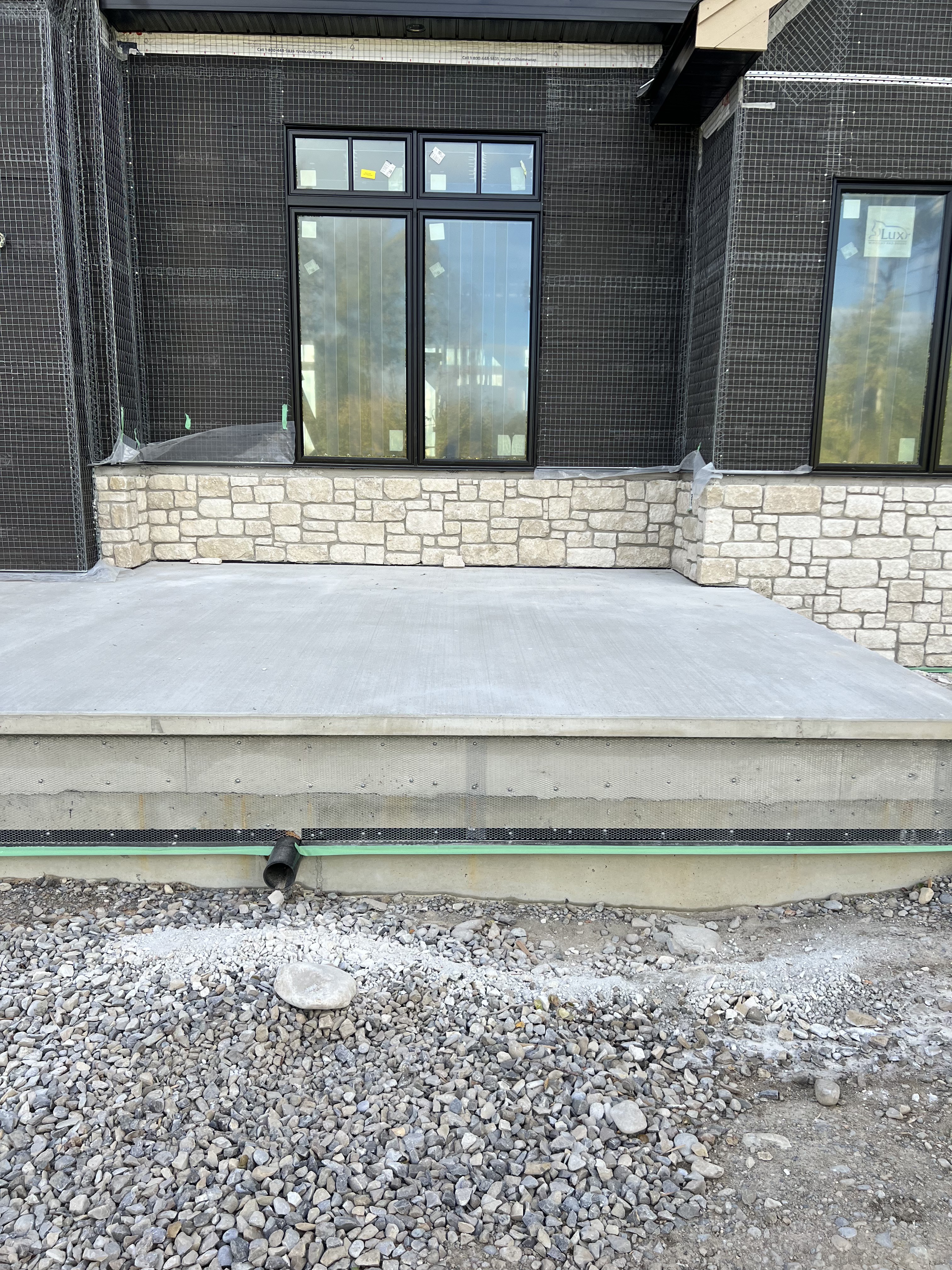 Cream stone porch wainscot with black brick