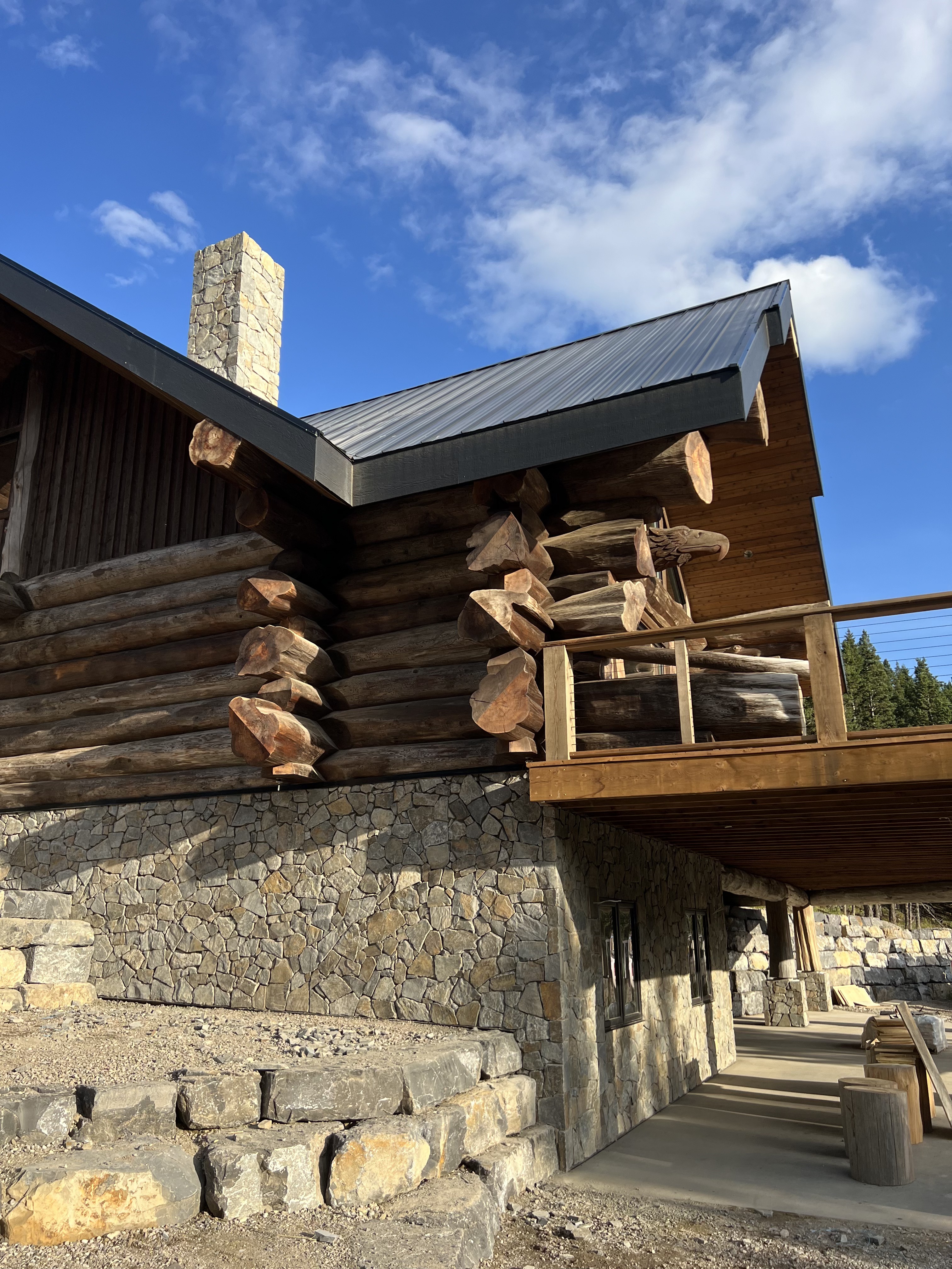 Log cabin with stone foundation and mountain view