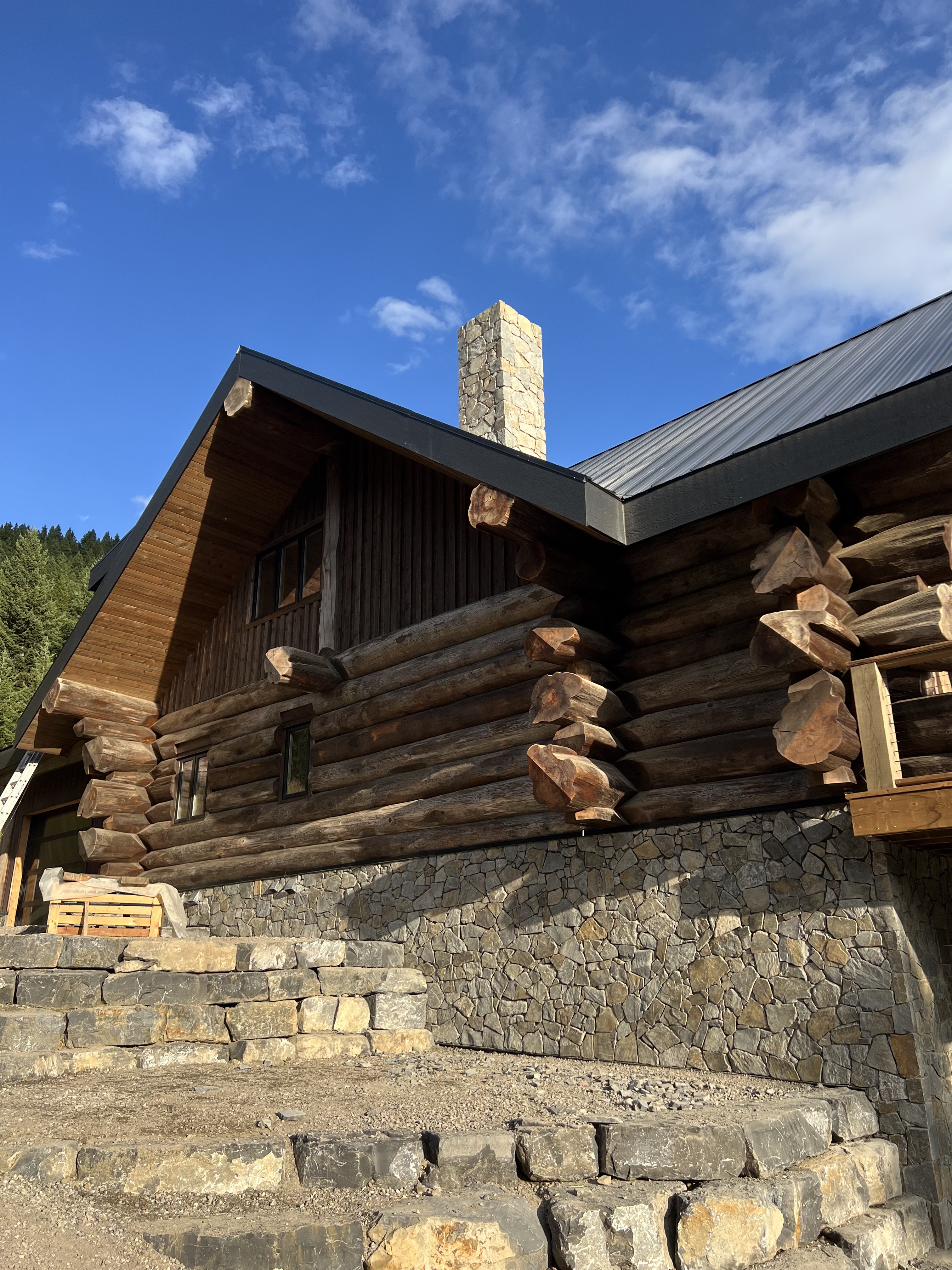 Log home with stone base and gable