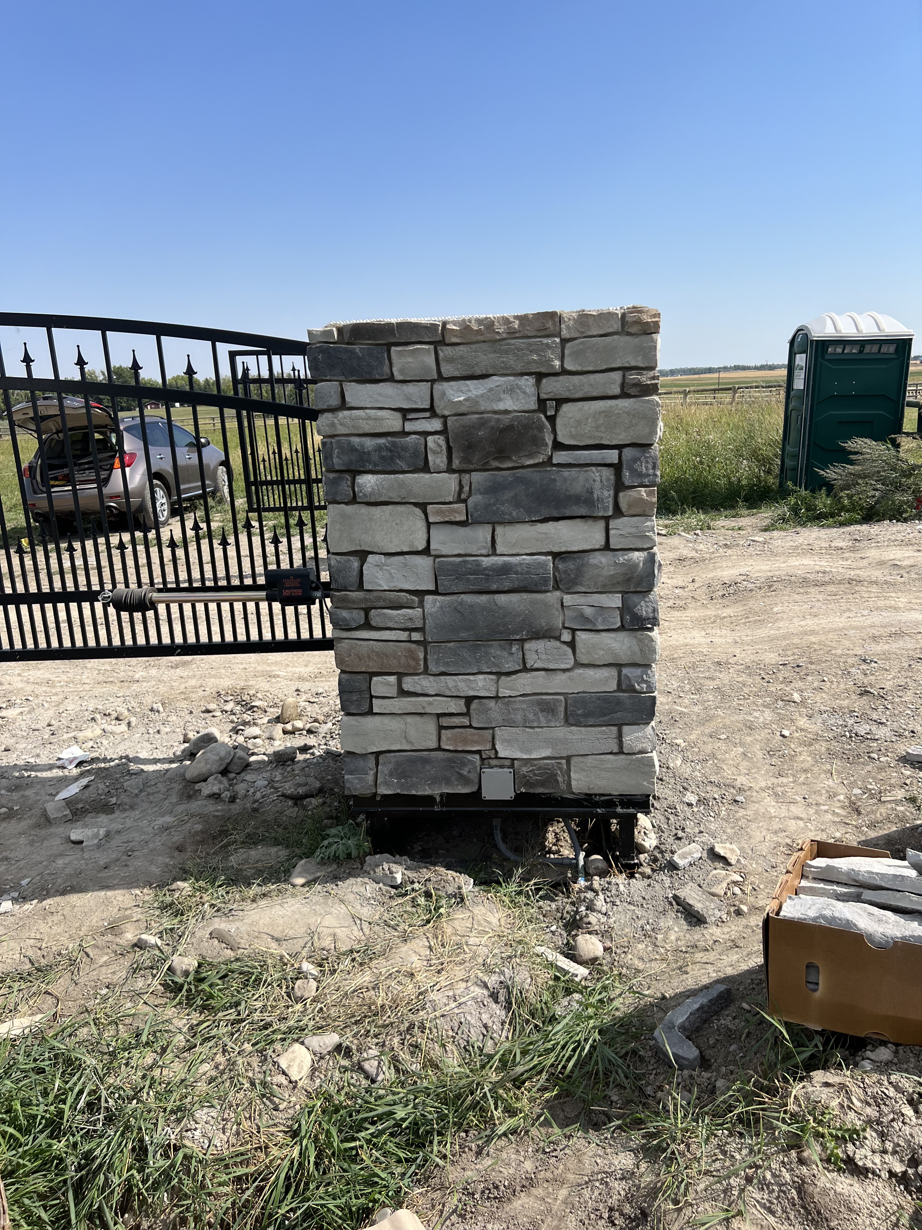 Hand-built stone gate post on a Calgary acreage