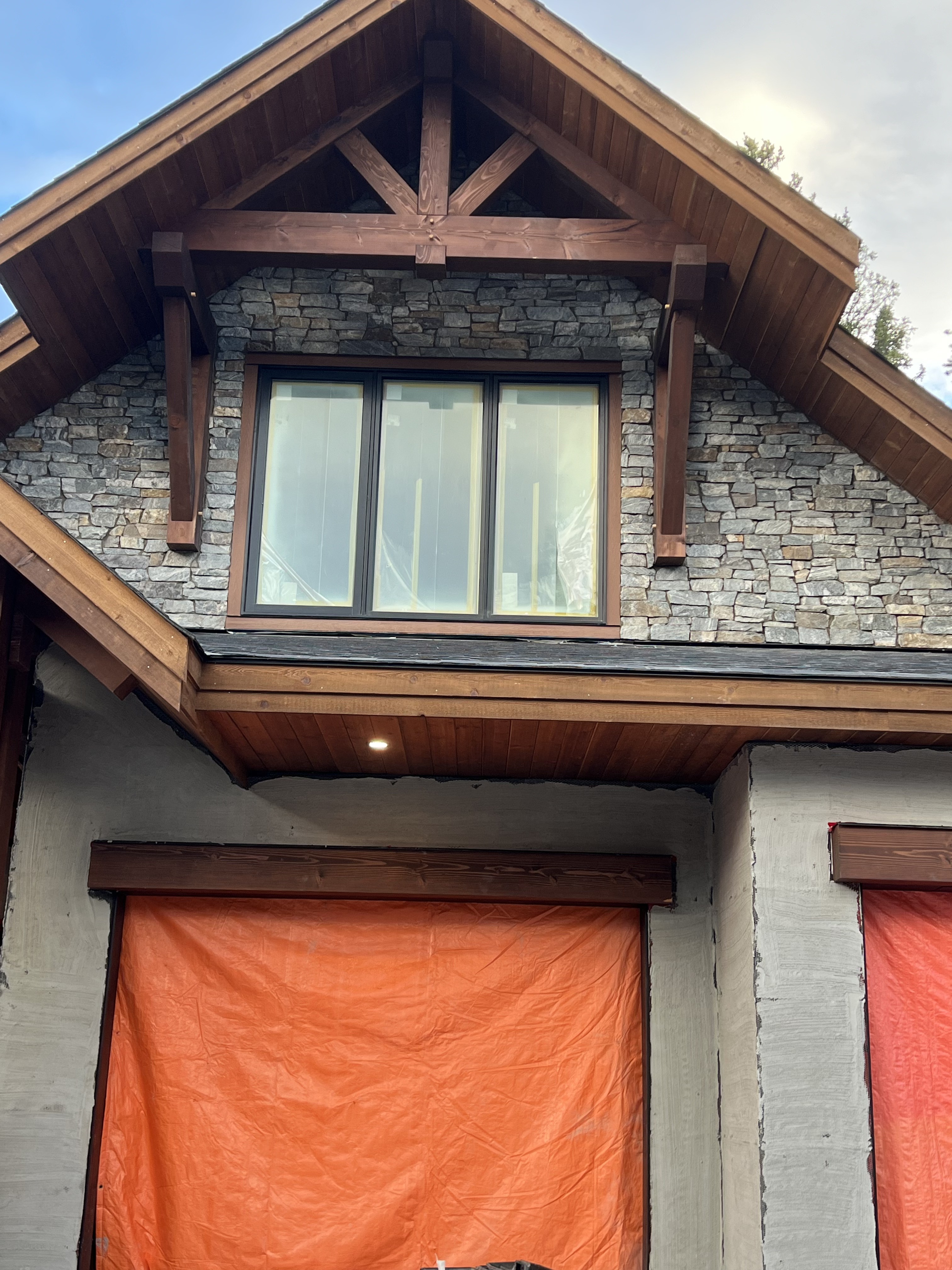 Timber frame gable with stone facade